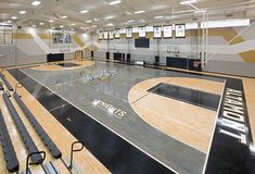 an empty basketball court with benches and seats