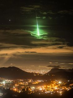 an object is seen in the sky over a city at night with lights on it