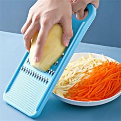 a person grating cheese on top of a plate with carrots next to it