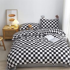 a black and white checkered comforter on a bed in a room with two nightstands