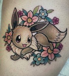 an image of a pokemon tattoo with flowers on the side of her thigh and a pikachu