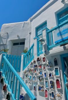 there is a blue and white building with many pictures on the wall next to it