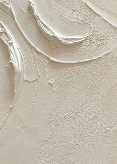 an abstract painting with white paint on the wall