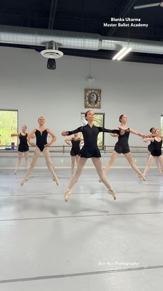 a group of ballet dancers in black leotards