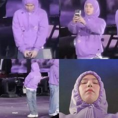 a man in a purple hoodie looking at his cell phone