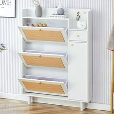 a white bookcase with three open compartments on the front and two closed drawers on the back