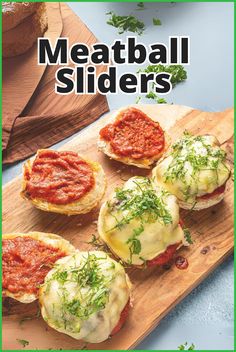 a wooden cutting board topped with mini meatball sliders