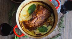 a pot filled with food on top of a wooden table