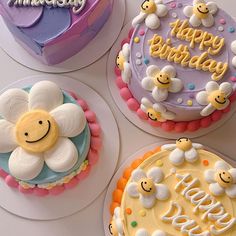 four decorated birthday cakes sitting next to each other