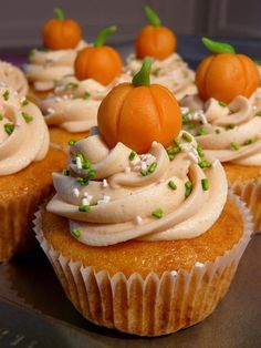 cupcakes with white frosting and green sprinkles