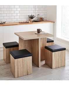 a kitchen table with four stools next to it