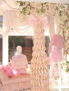 a room filled with mannequins and dresses on display in front of a window