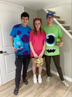 three people in costumes standing next to each other