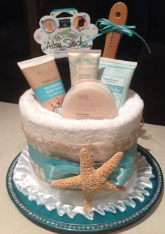 a baby shower gift basket on a blue and white plate with a starfish decoration