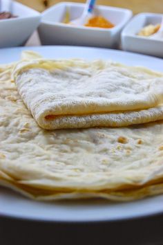 two tortillas sitting on top of a white plate