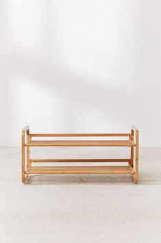 a wooden bench sitting on top of a white floor