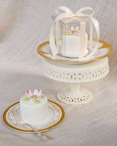 a small white cake sitting on top of a table next to a piece of cake