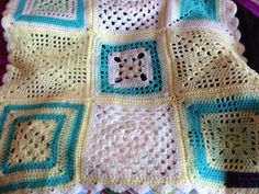 a crocheted blanket with squares on it