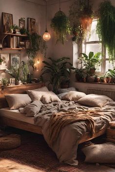 a bed with lots of pillows and plants on the headboard in a room filled with potted plants