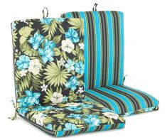 a pair of outdoor chairs with blue and green flowers on the seat cushions, both facing each other