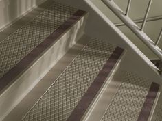 a close up view of some stairs with metal bars on the bottom and side rails