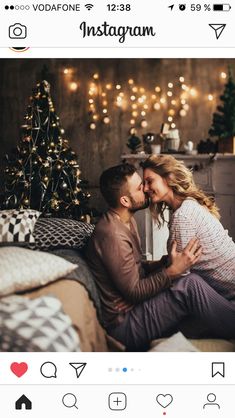 a couple kissing in bed with christmas lights on the wall behind them and an instagramr