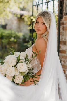 a woman in a wedding dress holding a bouquet