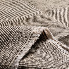 a close up view of a gray and white checkered blanket