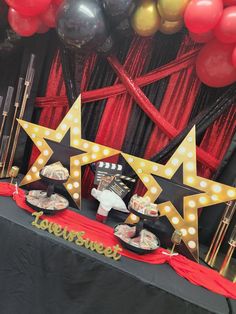 a table topped with lots of food and balloons