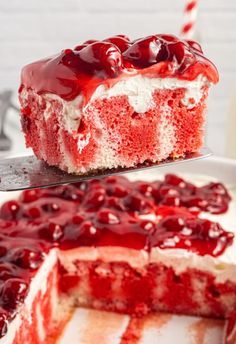 a piece of red velvet cake with white frosting and cherries