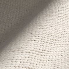 an up close shot of the textured fabric on a white bed sheeting material