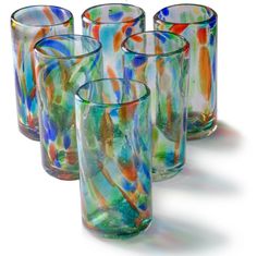 four colorful glasses are lined up in a row