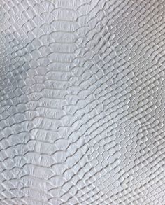 an up close view of the texture of white leather with wavy lines and ridges on it