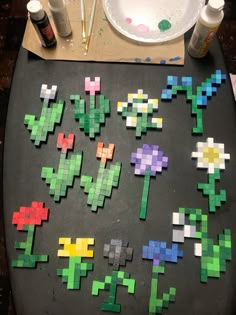 the pixel art work is being made with colored blocks and glues on a table