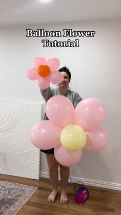 a woman is holding balloons in front of her face with the caption balloon flower