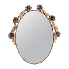 a round mirror with flowers on the edge and an ornate frame around it, against a white background