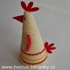 a crocheted chicken sitting on top of a white table