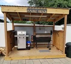 an outdoor bbq with grills and barbecue equipment