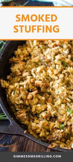 a skillet filled with cooked stuffing on top of a wooden table next to green onions