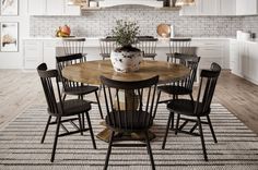 a dining room table with chairs around it