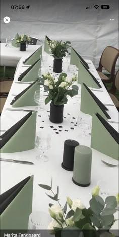 a long table is set up with flowers and place settings