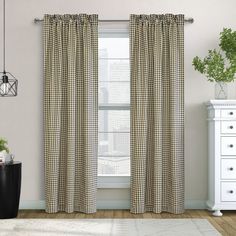 a living room with white furniture and curtains