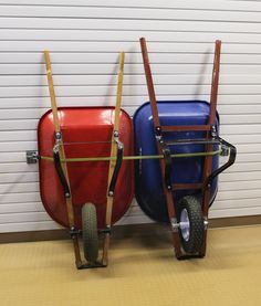 two colorful luggage carts sitting next to each other in front of a white garage door