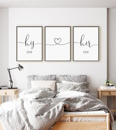 two posters on the wall above a bed in a room with white walls and wooden furniture