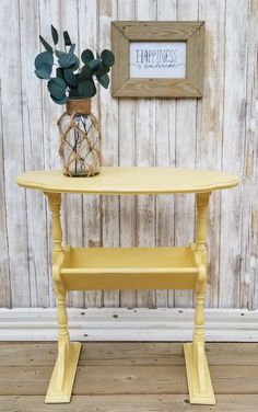 a small yellow table with a plant on top