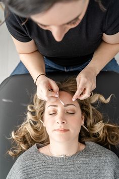 a woman getting her hair styled by another woman