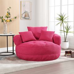 a living room with a large pink round chair