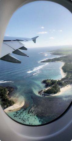 an airplane window looking out at the ocean