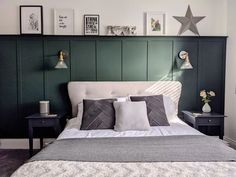 a bedroom with green paneled headboard and white bedding, two nightstands on either side