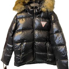 Elevate Your Winter Wardrobe With This Stylish Men's Puffer Jacket From Guess. The Jacket Features A Brown Faux Fur Hood And Zipper Accents For A Trendy Look. It's Made With High-Quality Materials And Is Designed To Keep You Warm And Comfortable In Cold Weather. The Jacket Comes In Size L And Features A Zip Closure. This Jacket Is Perfect For Men Who Want To Stay Warm While Looking Fashionable. It's A Great Addition To Any Winter Wardrobe And Is Sure To Turn Heads. Don't Miss Out On This Must-Ha Guess Puffer Jacket, Puffer Jacket With Fur, Mens Puffer Jacket, Jacket Fur, Man Clothes, Black Puffer Jacket, Guess Men, Puffy Jacket, Black Puffer